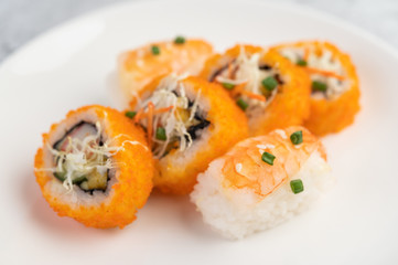 Sushi is beautifully arranged on the plate.