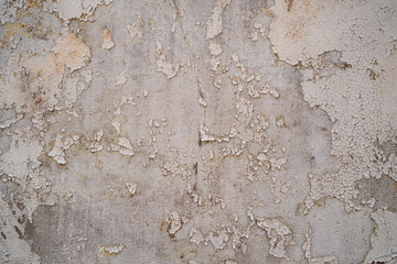 Concrete wall with old cracked white painting background