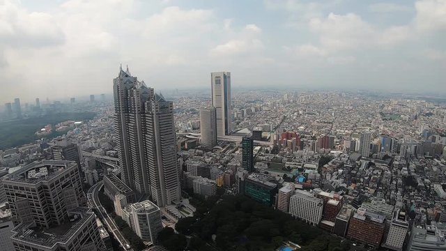 Slow pan of buildings in Tokyo skyline from Shinjuku, 100fps