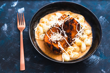 plant-based food, vegan tomato pesto potato gnocchi with oven roaste butternut squash pumpkin chunk and dairy-free cheese topping