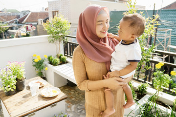 muslim woman and kids breakfast at home on the rooftop garden