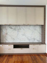 Object behind furniture on parquet flooring