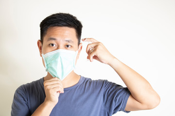 asian man wearing surgical mask protect contagious disease corona virus bacteria covid19 outbreak