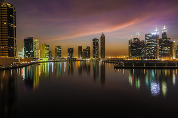 Fototapeta na wymiar Sunrise over pond in a city. Kuala Lumpur skyline