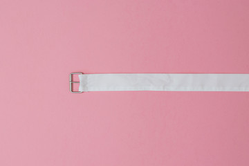 White material belt on a red background. The concept of differentiation.