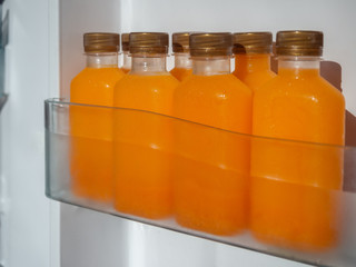 Orange juice iced cold in the bottles.