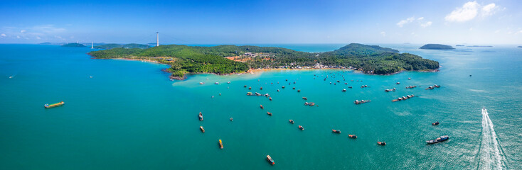 Aerial view of white sand beach and boat on the blue lagoon aqua sea. Royalty high quality free...