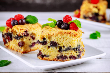 Berry sour cream cake cut into squares.