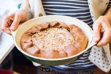 A piece of baked apple, nuts tart, pie or cake. Vegan sweet dessert on plate.