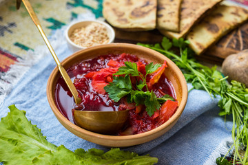 Red borsch - homemade Russian traditional vegetables soup with cabbage, sauerkraut, beetroot and parsley. Vegan healthy food. Ingredients