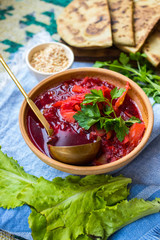 Red borsch - homemade Russian traditional vegetables soup with cabbage, sauerkraut, beetroot and parsley. Vegan healthy food. Ingredients