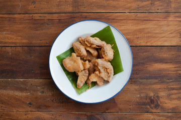 Thai food Fried Pork Intestine on wooden table, top view. Famous food eating with alcohol drink