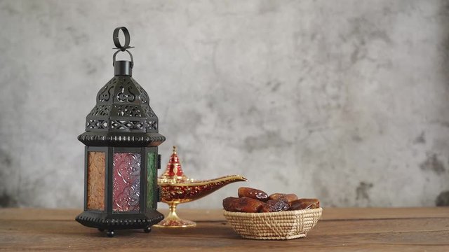 On table top image of decorations Ramadan Kareem holiday background.Close up Arabic lantern metal date and milk on brown wooden.Halal meal set for fasting is obligatory for Muslim.
