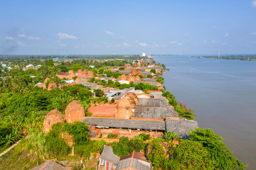 Mang Thit brick kiln in Vinh Long. Burnt clay bricks used in traditional construction of Vietnamese. Mekong Delta, Vinh Long, Vietnam. View from river.