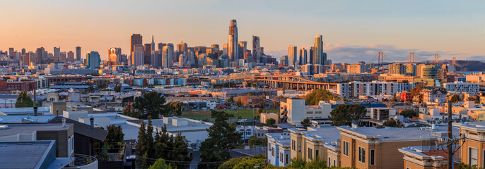 Obraz premium San Francisco city skyline panorama after sunset with city lights, the Bay Bridge and highway leading into the city