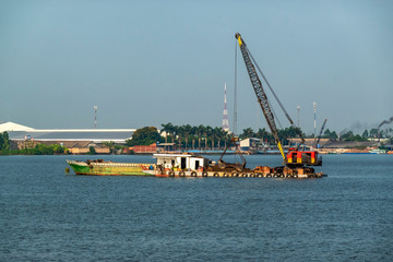 Exploiting sands on the Mekong River. Boats carrying sand on the river in Vinh Long, Vietnam.
