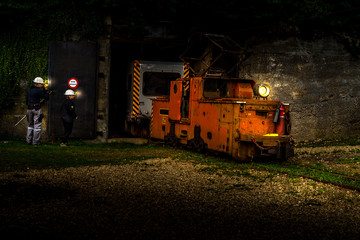 Mining train locomotive going out of the mine