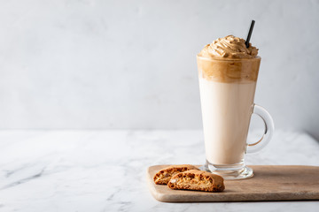 Trendy korean whipped coffee Dalgona on a licht background. 