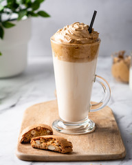 Trendy korean whipped coffee Dalgona on a licht background. 
