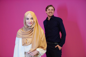 portrait of young muslim couple isolated on pink background