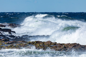 Spring gale wave hitting the shore