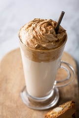 Trendy korean whipped coffee Dalgona on a licht background. 