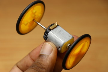 Dual Shaft dc motor which is modified from old toy dc motor so that work of two dc motor can be done by one motor