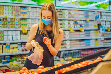 A woman chooses tomatoes in a supermarket without using a plastic bag. Reusable bag for buying vegetables. Zero waste concept