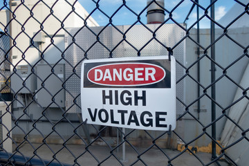 Danger high voltage sign on a fence