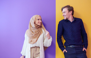 portrait of young muslim couple isolated on colorful background