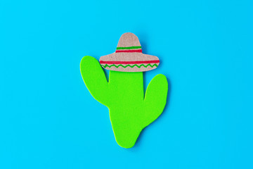 Cinco de Mayo with a Mexican cactus and a sombrero hat on a blue background. Fiesta, usa, mexican holiday.