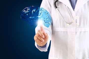 Female neurologist with digital model of brain on dark background