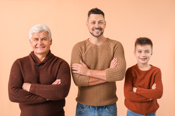 Man with his father and son on color background