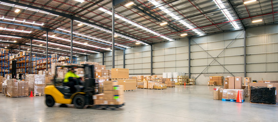 Forklift working at logistics warehouse