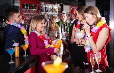 Young people on Hawaiian party at nightclub