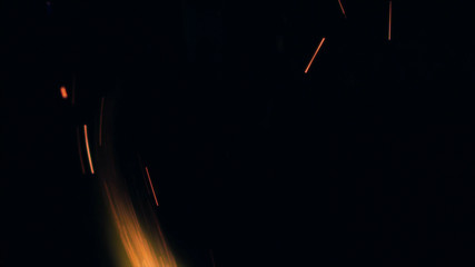 Macro photo of Bonfire sparks. Fire Flames bursts, blasts. Explosion micro sparkles. Mini...
