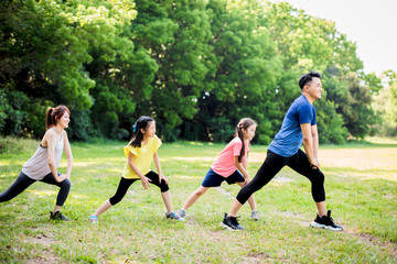 happy family exercising  together at the park