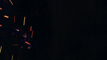 Macro photo of Bonfire sparks. Fire Flames bursts, blasts. Explosion micro sparkles. Mini...