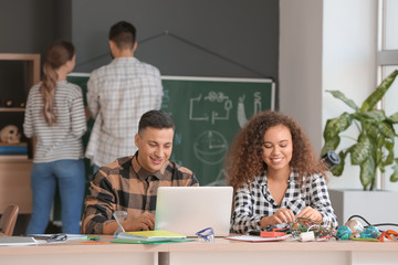 Young people at physics lesson in classroom
