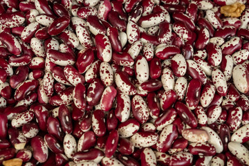Abstract background from bean kernels. Legume in the market. Natural products for a healthy diet. Protein, a protein from nature. Red, white, colorful, pink beans.