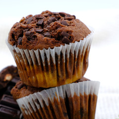Homemade delicious chocolate muffin on wooden background close-up