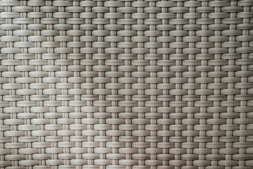 Abstract background of wicker stripes of matting. Texture and patterns handmade. Outdoor furniture close-up.