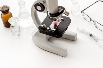 Laboratory examination with microscope. Equipment with blood sample on white background