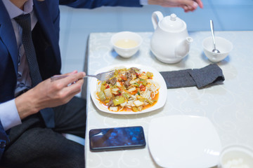 Man eating noodles in a cafe during lunch