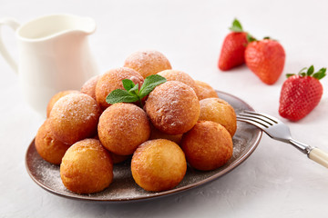 Beautiful breakfast. Cottage cheese donuts  balls  on a light background.