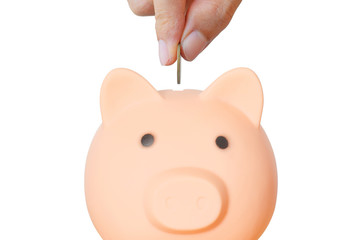 money saving concept. business hand putting golden coin in to piggy bank with stack coins on wood table isolated on white background for save and investment. financial and banking.