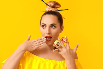 Beautiful woman with tasty sushi on color background