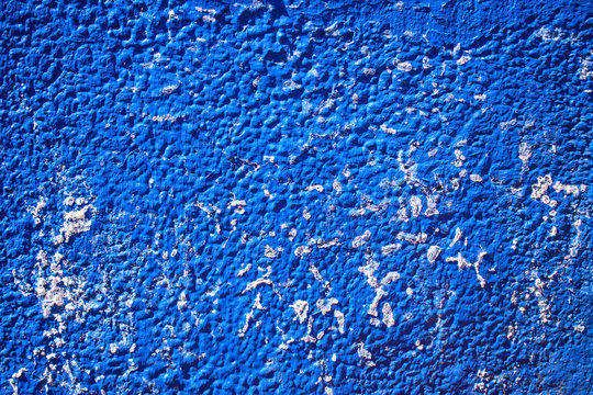 Wall with old paint and squeezing salt. White crystals, cracks, peeling. Color Dodger Blue.