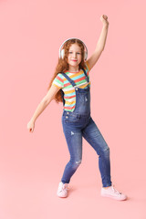 Cute little girl listening to music on color background