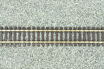 Fine grey gravel background used as track ballast for model railways with section of track